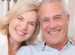 Couple smiling after getting dental crowns raleigh