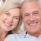 Couple smiling after getting dental crowns raleigh