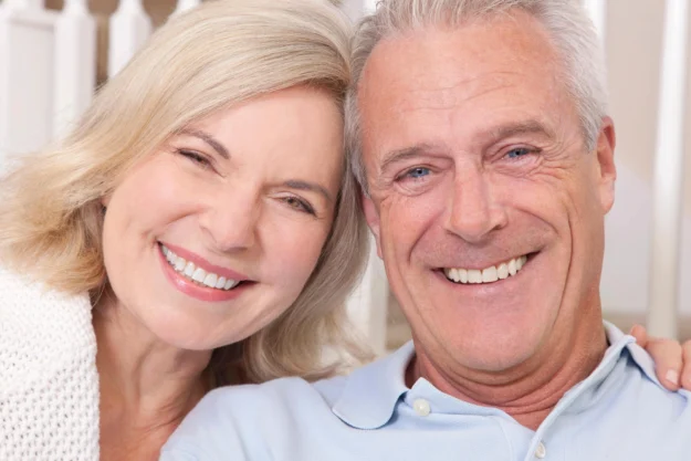 Couple-smiling-after-getting-dental-crowns-raleigh Couple smiling after getting dental crowns raleigh