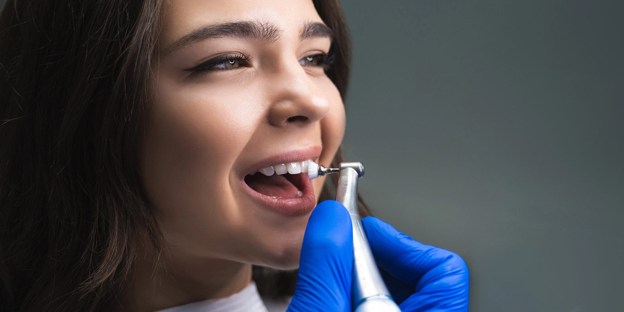 Girl cleaning her veneers raleigh nc