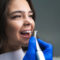 Girl cleaning her veneers raleigh nc
