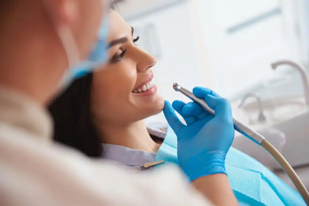 Woman getting dental crowns raleigh