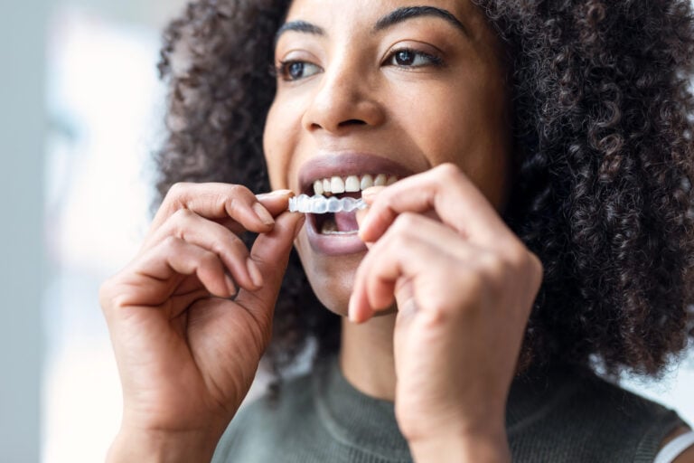 Woman wearing her aligners after getting invisalign raleigh nc