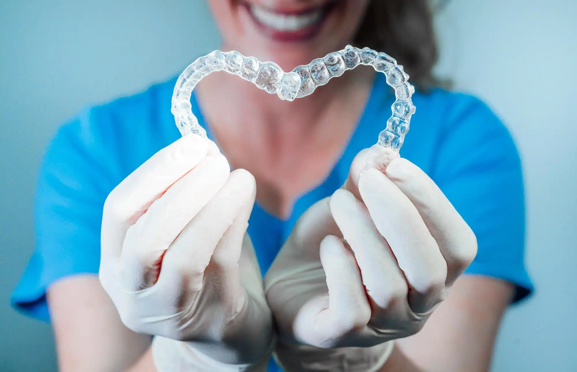 Dentist holding invisalign raleigh nc