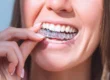 Woman putting invisalign raleigh nc