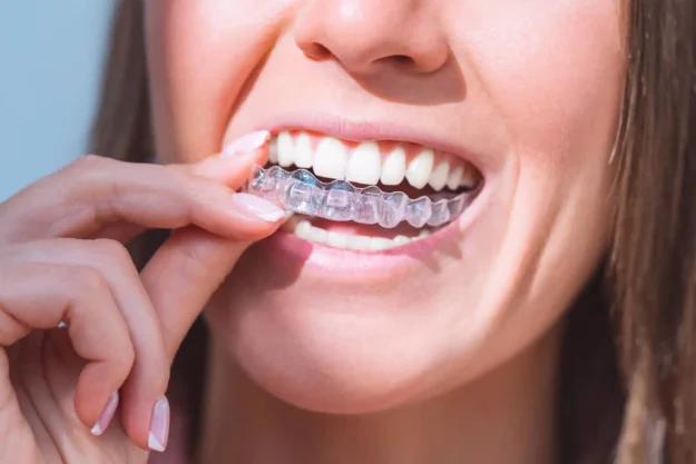 Woman putting invisalign raleigh nc